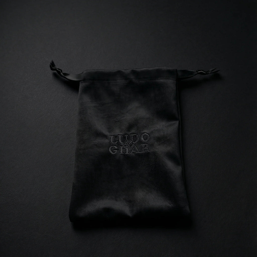 Ludo Ghar velvet pouch holding premium Ludo board game pieces