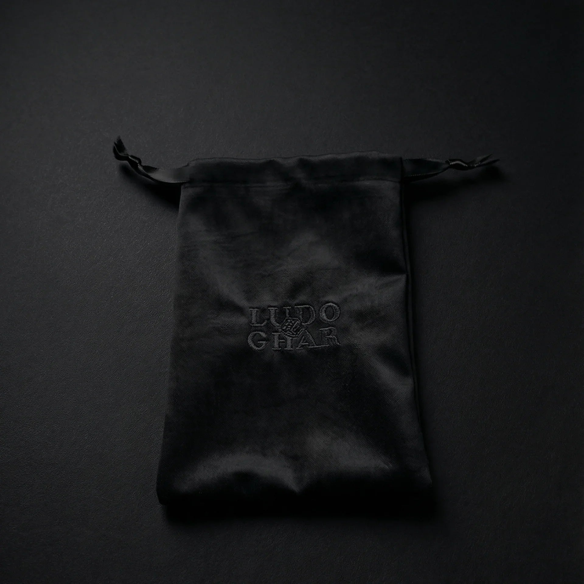 Ludo Ghar velvet pouch holding premium Ludo board game pieces